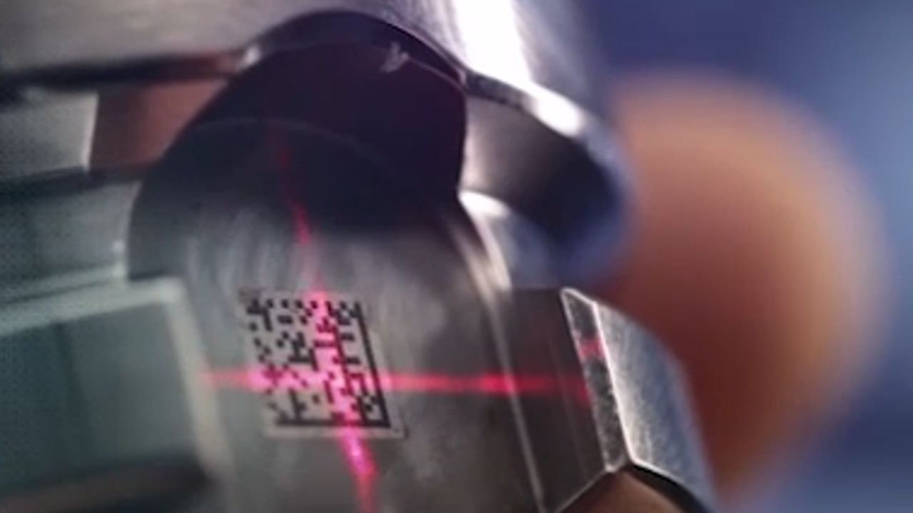 A QR code lasered into a metal tool is scanned