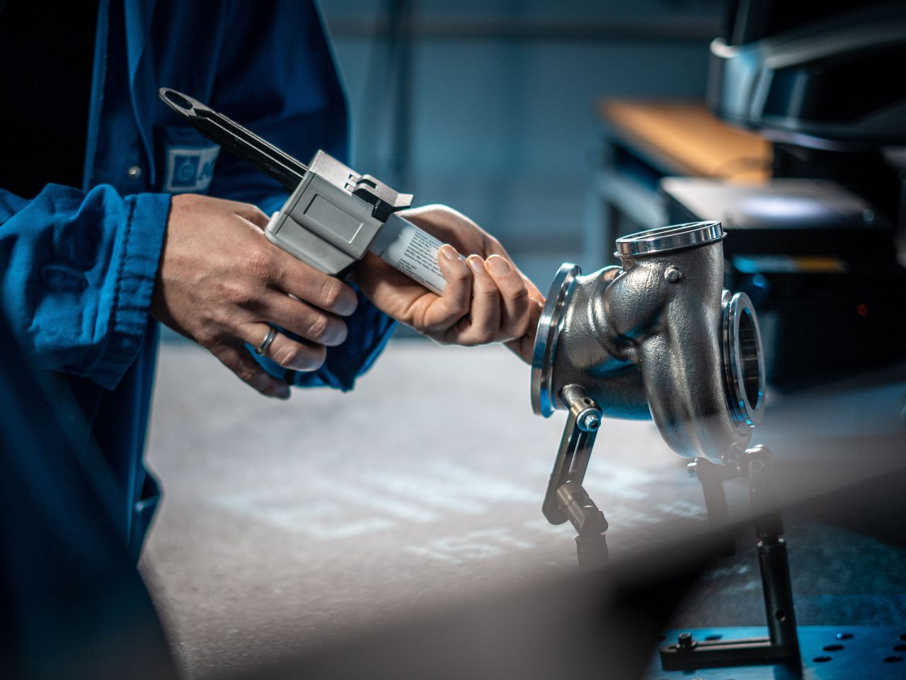 an employee injects a silicone compound into a turbocharger